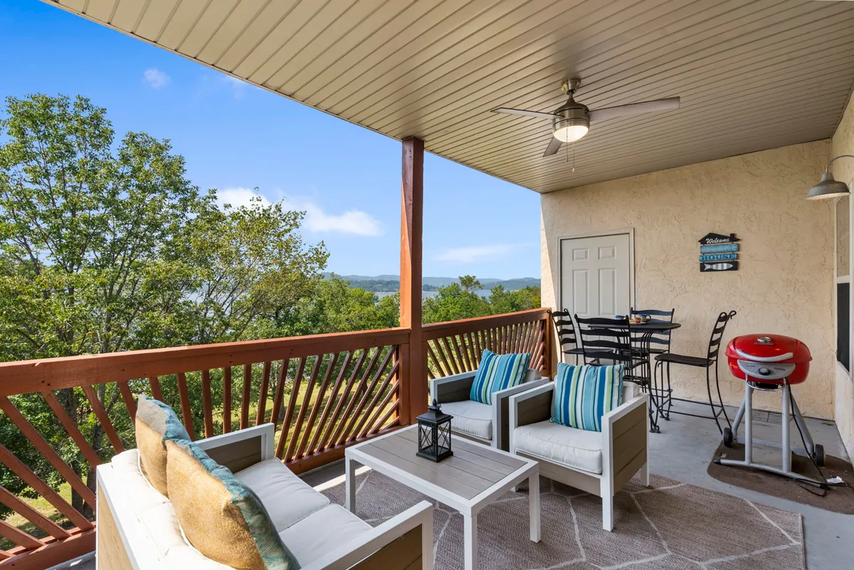This image showcases a comfortable outdoor seating area with a grill and sweeping views of the landscape. The setup invites gatherings, family barbecues, and relaxed evenings outside, tying directly to the section's mention of a balcony with a grill and summer evenings spent together.